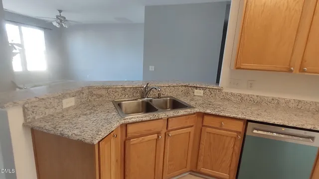 an empty room with windows and fireplace