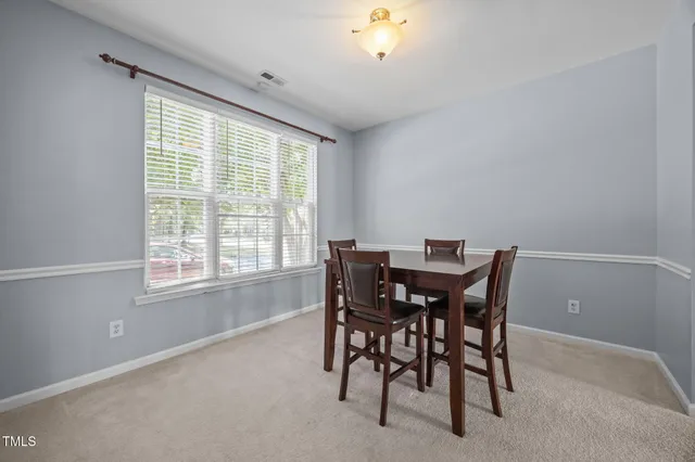 a view of a livingroom with a fireplace and chandelier fan
