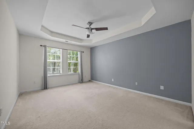 a large kitchen with a large window and stainless steel appliances