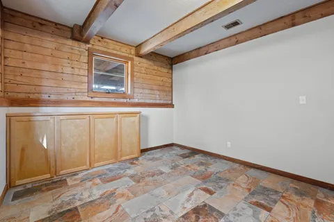 a bathroom with a granite countertop sink a toilet and shower