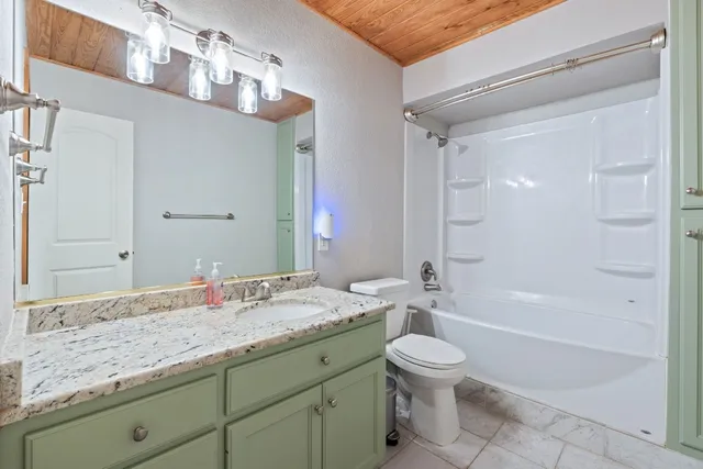 a bathroom with a tub sink and mirror