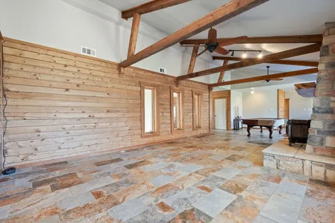 a living room with furniture and large windows