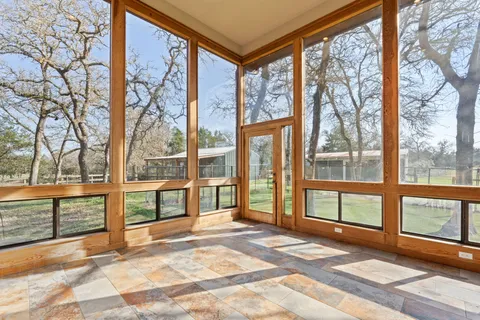 a view of front door with lots of furniture and a large window