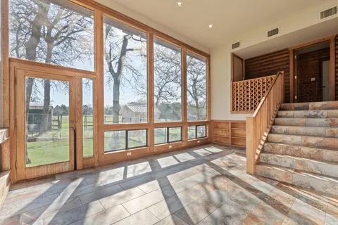 a view of entryway hall and wooden floor
