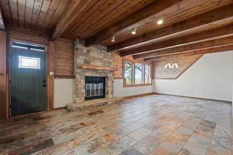 a view of empty room with a fireplace