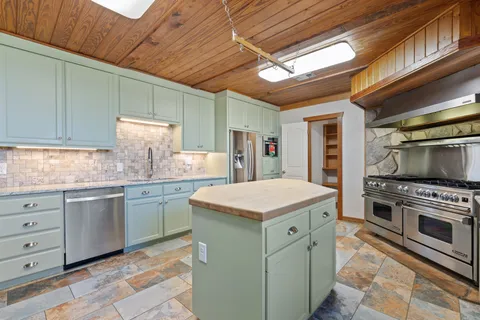 a kitchen with a refrigerator and a sink