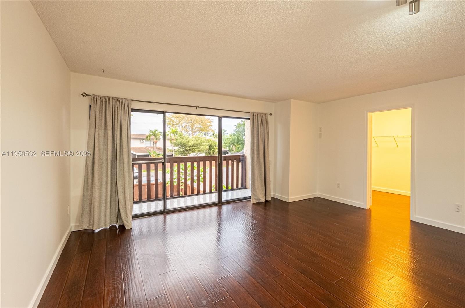 6534 Southwest 114th Place, Unit G75 Miami, FL 33173 - Photo 21 of 52 a view of an empty room with wooden floor and a window