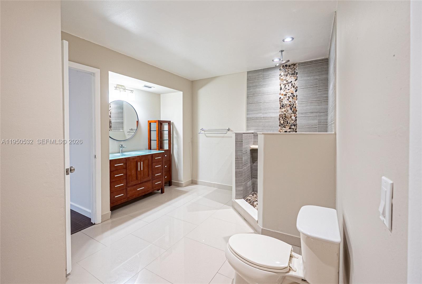 6534 Southwest 114th Place, Unit G75 Miami, FL 33173 - Photo 28 of 52 a bathroom with a toilet a sink and mirror