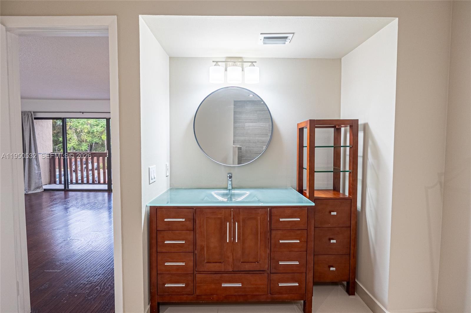 6534 Southwest 114th Place, Unit G75 Miami, FL 33173 - Photo 30 of 52 a bathroom with a granite countertop sink a mirror and a vanity