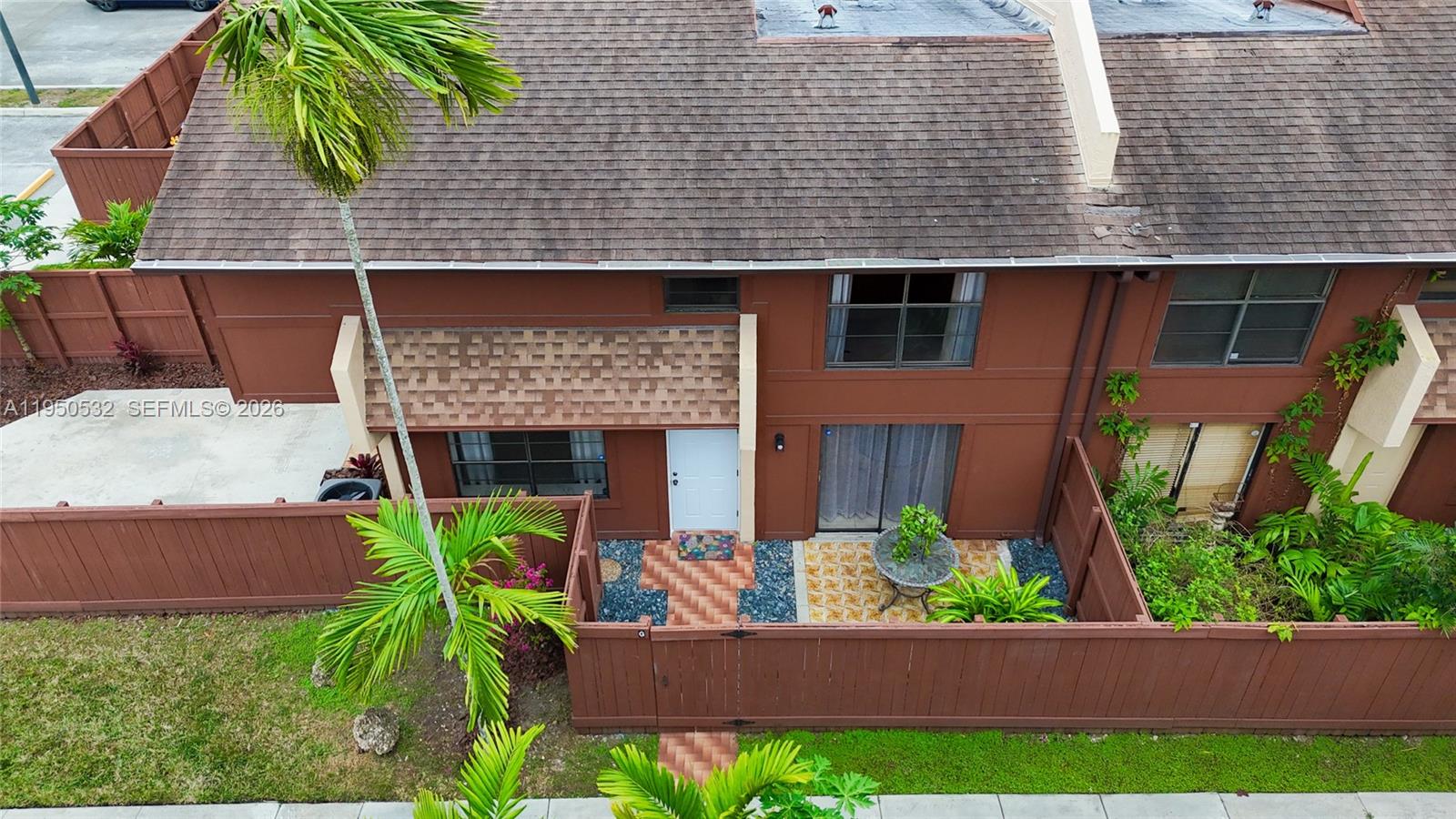 6534 Southwest 114th Place, Unit G75 Miami, FL 33173 - Photo 36 of 52 a front view of a house with garden