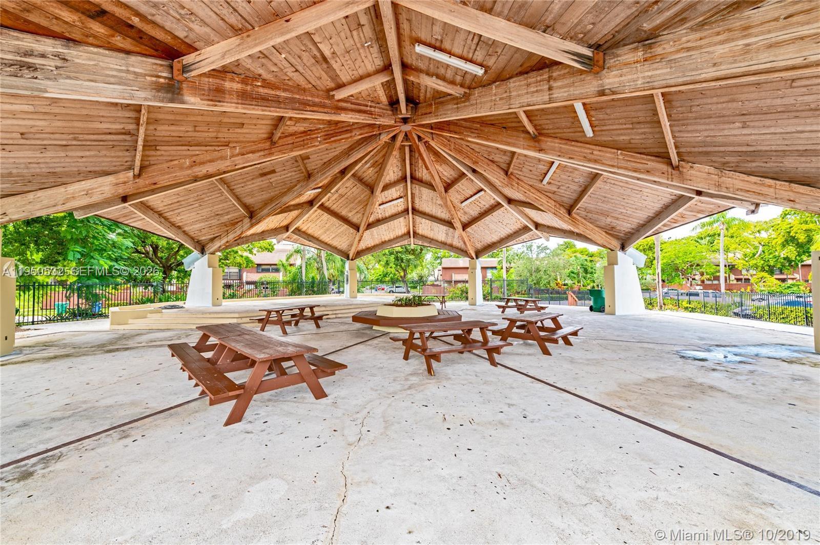 6534 Southwest 114th Place, Unit G75 Miami, FL 33173 - Photo 43 of 52 a view of a backyard with sitting area and furniture