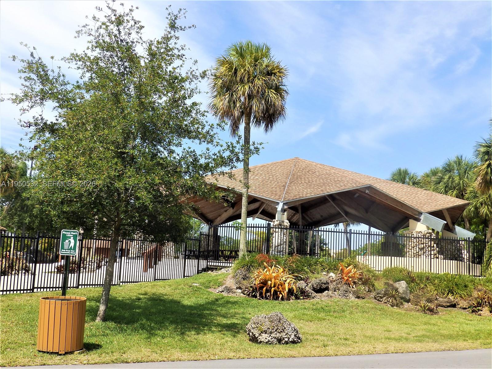 6534 Southwest 114th Place, Unit G75 Miami, FL 33173 - Photo 44 of 52 a view of a patio with table and chairs under an umbrella