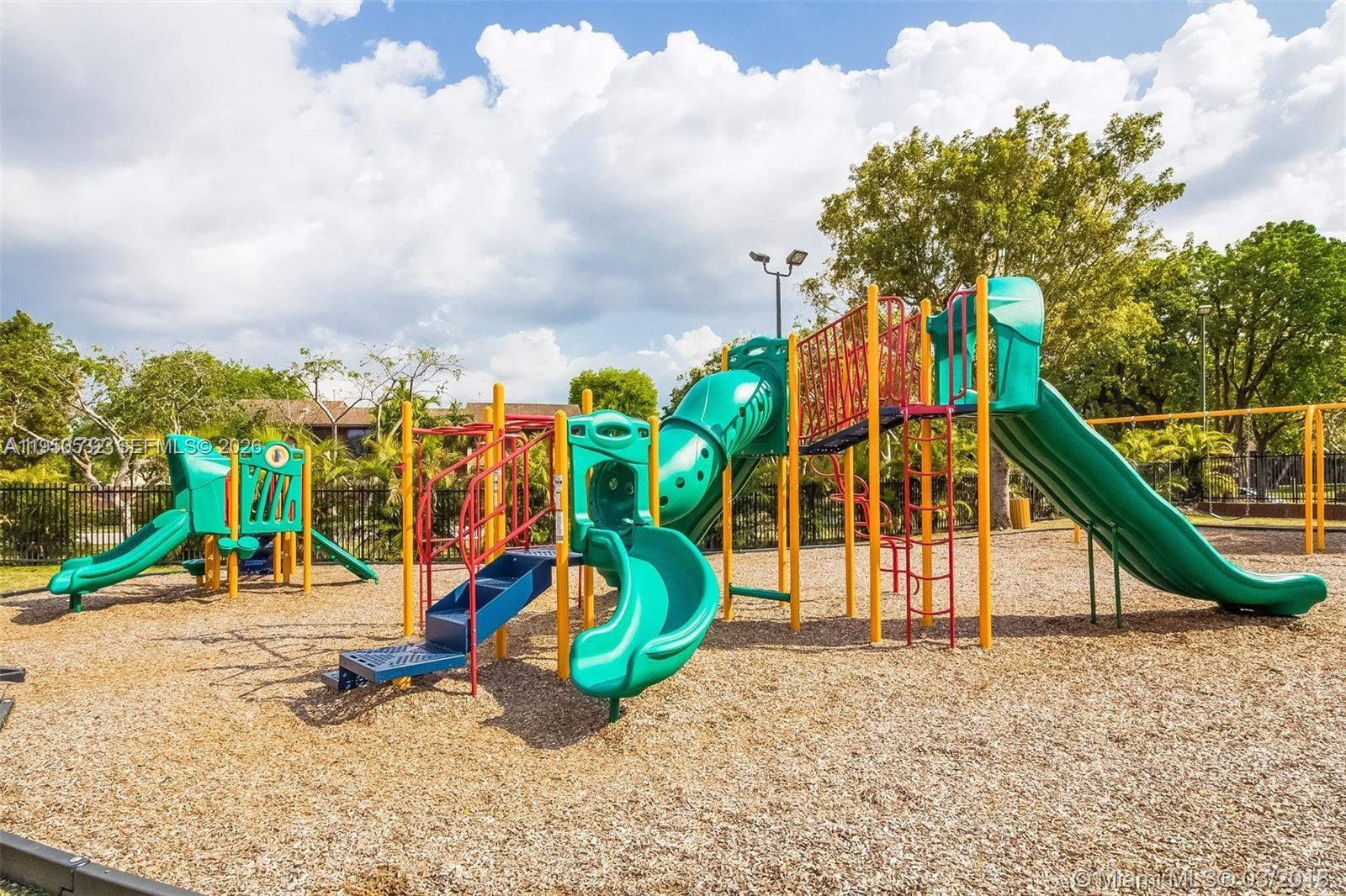 6534 Southwest 114th Place, Unit G75 Miami, FL 33173 - Photo 46 of 52 an aerial view of a park with slide and entertaining space