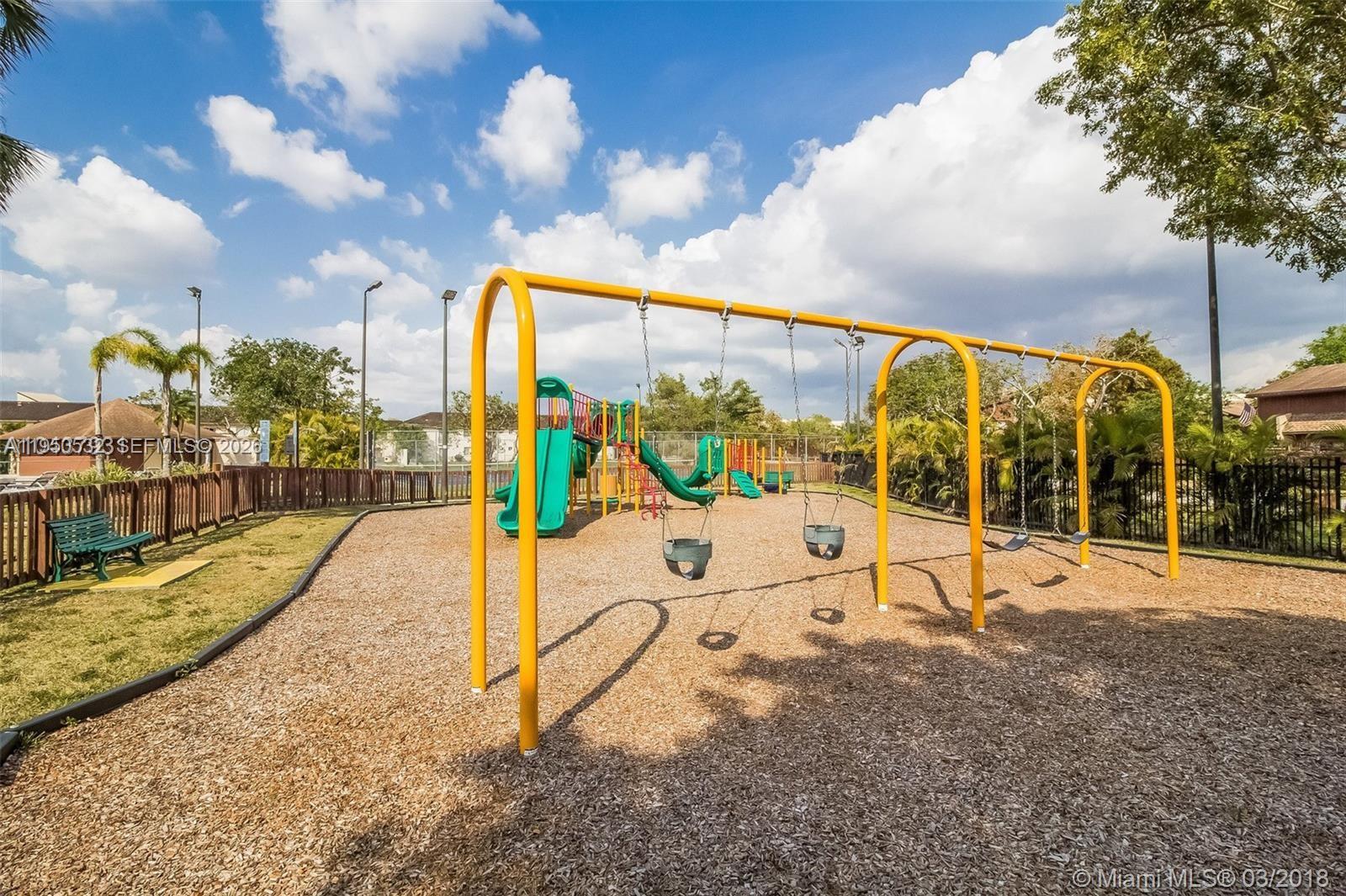 6534 Southwest 114th Place, Unit G75 Miami, FL 33173 - Photo 48 of 52 a view of a swimming pool with a patio