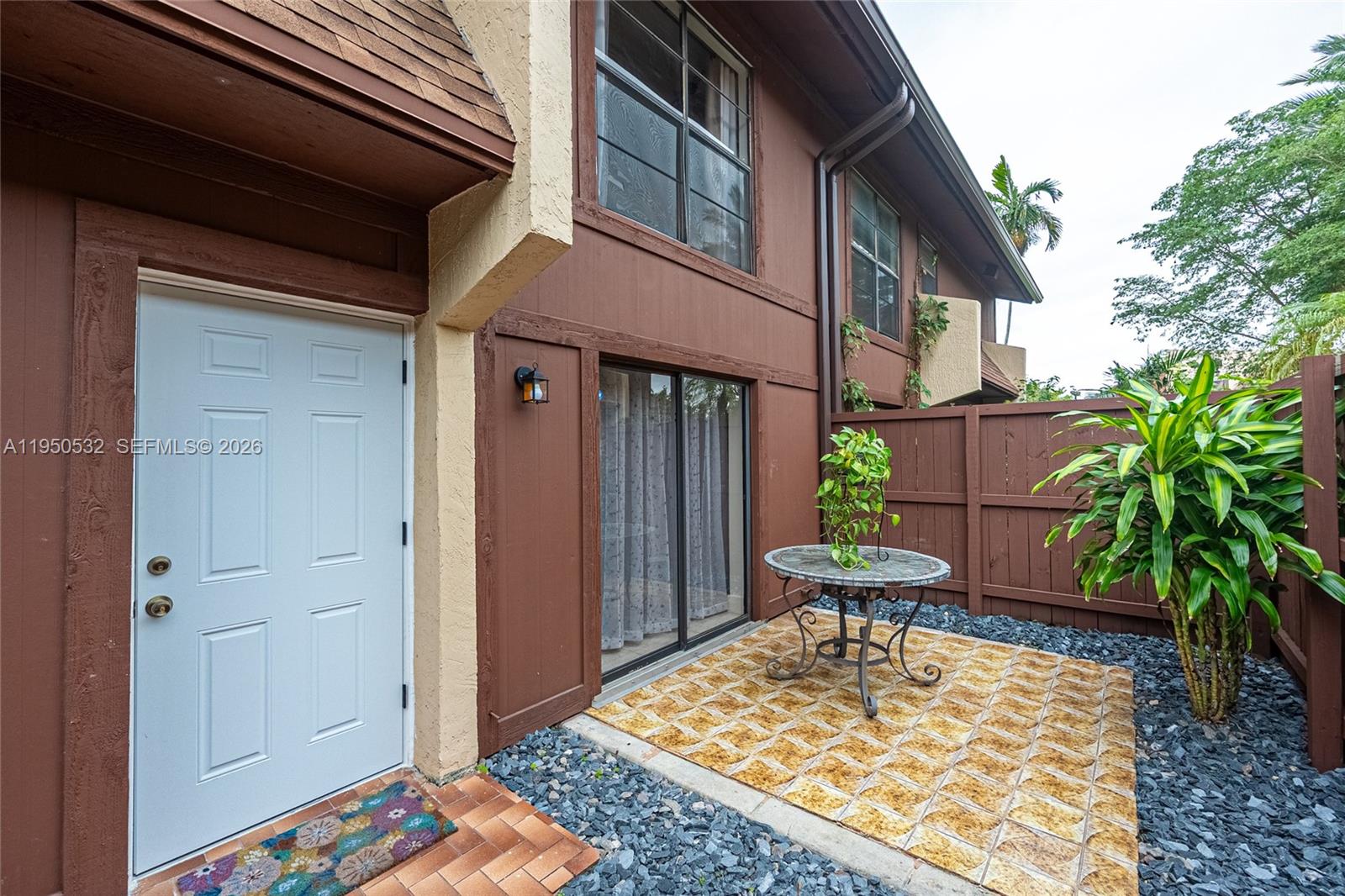 6534 Southwest 114th Place, Unit G75 Miami, FL 33173 - Photo 5 of 52 a view of a chair and table in the patio of a house