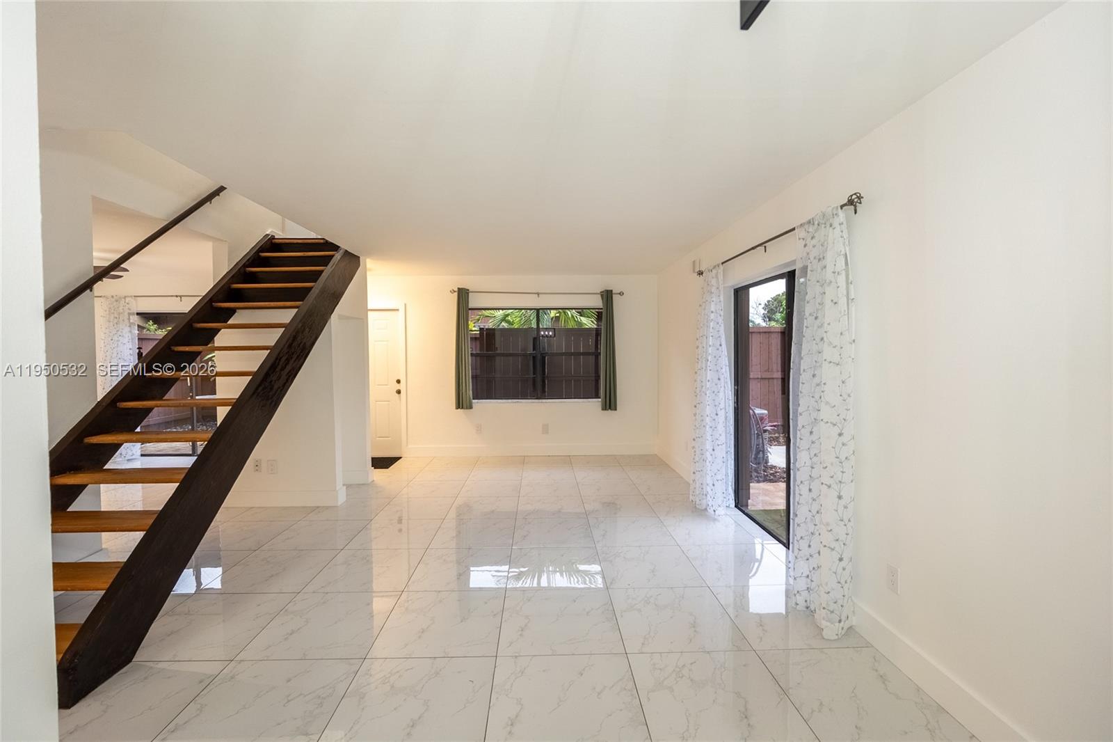 6534 Southwest 114th Place, Unit G75 Miami, FL 33173 - Photo 9 of 52 a view of entryway with stairs and a window
