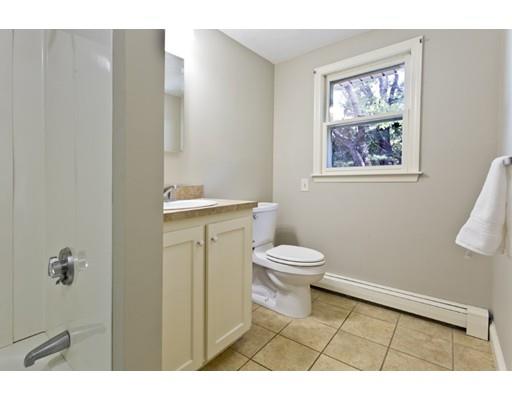 8 Rustic Lane Reading, MA 01867 - Photo 17 of 29 a bathroom with a toilet a sink and a window