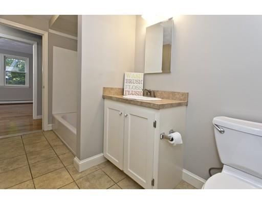 8 Rustic Lane Reading, MA 01867 - Photo 18 of 29 a bathroom with a toilet sink and mirror