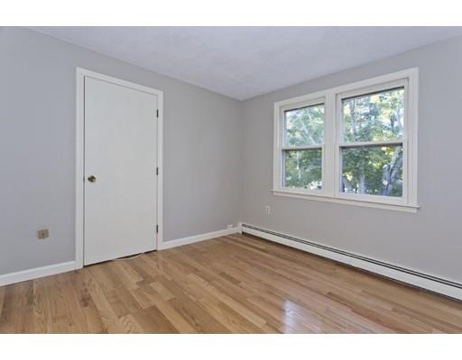 8 Rustic Lane Reading, MA 01867 - Photo 19 of 29 a view of an empty room with wooden floor and a window