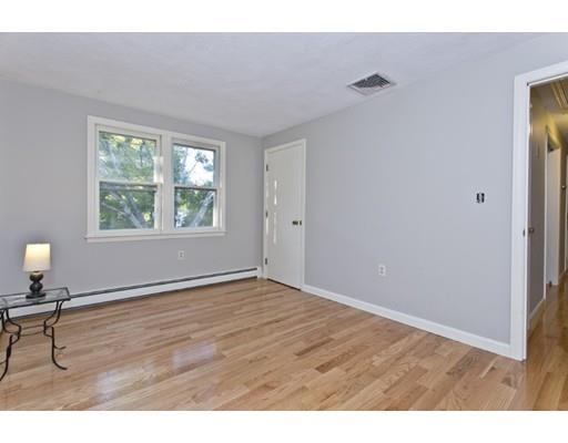 8 Rustic Lane Reading, MA 01867 - Photo 20 of 29 a view of an empty room with wooden floor and a window
