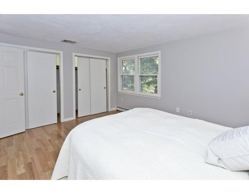 8 Rustic Lane Reading, MA 01867 - Photo 22 of 29 a bedroom with a bed and a window