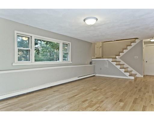 8 Rustic Lane Reading, MA 01867 - Photo 27 of 29 a view of an empty room with wooden floor and a window