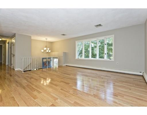 8 Rustic Lane Reading, MA 01867 - Photo 9 of 29 a view of an empty room with wooden floor and a window