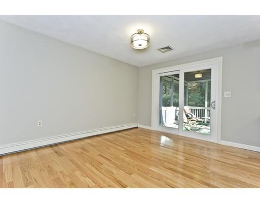 8 Rustic Lane Reading, MA 01867 - Photo 10 of 29 a view of an empty room with wooden floor and a window