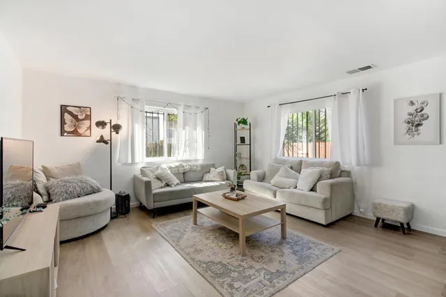 a view of a livingroom with furniture and a workspace