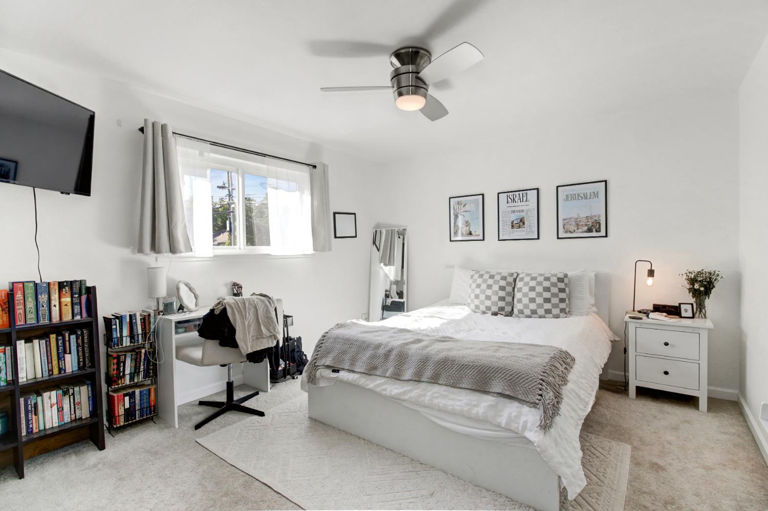 1916 17th Street Sacramento, CA 95811 - Photo 20 of 33 a bedroom with a bed a couch and book shelf