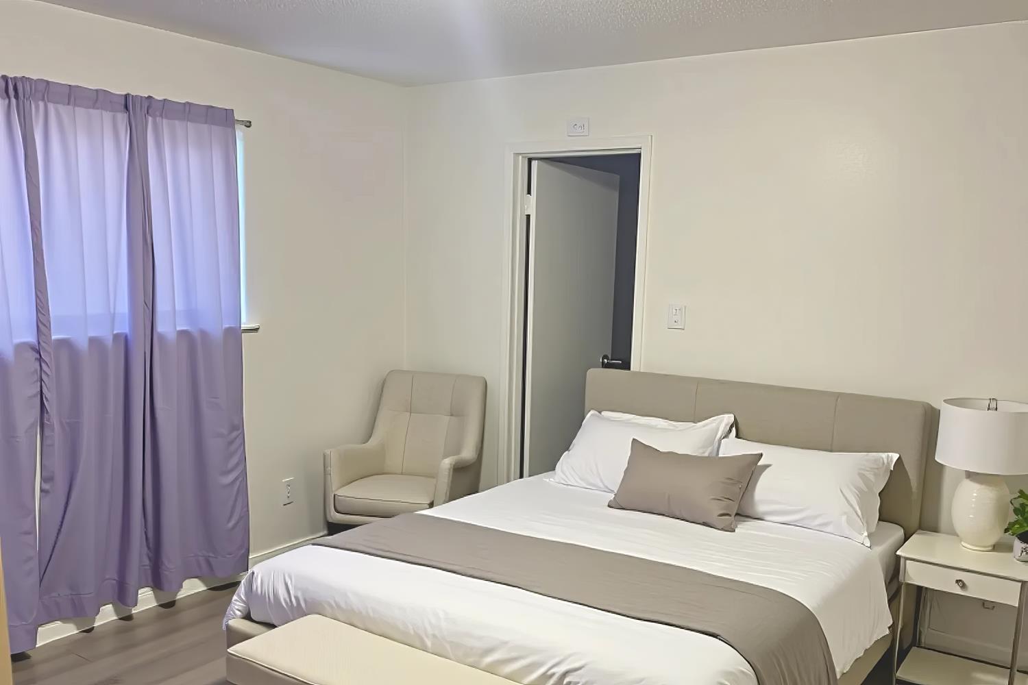 1916 17th Street Sacramento, CA 95811 - Photo 26 of 33 a bedroom with a bed and a chair