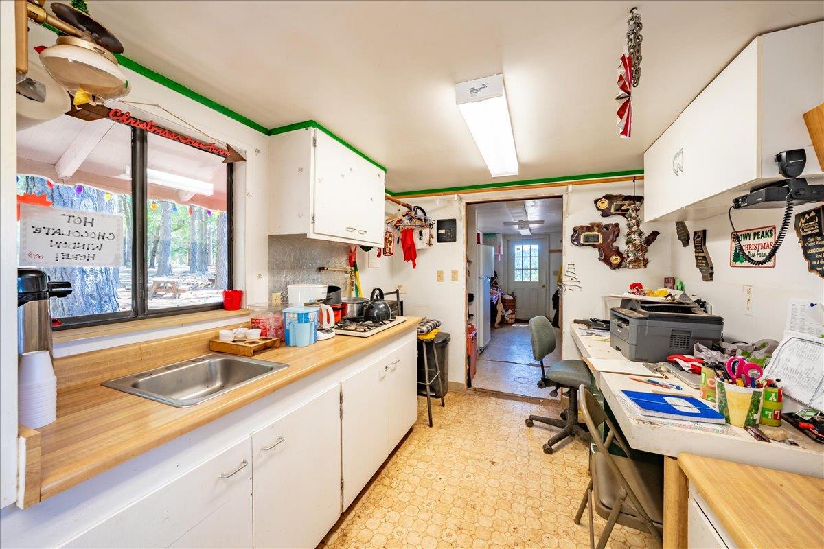 30100 Foresthill Road Foresthill, CA 95631 - Photo 9 of 89 a kitchen filled with a white stove top oven and cabinets