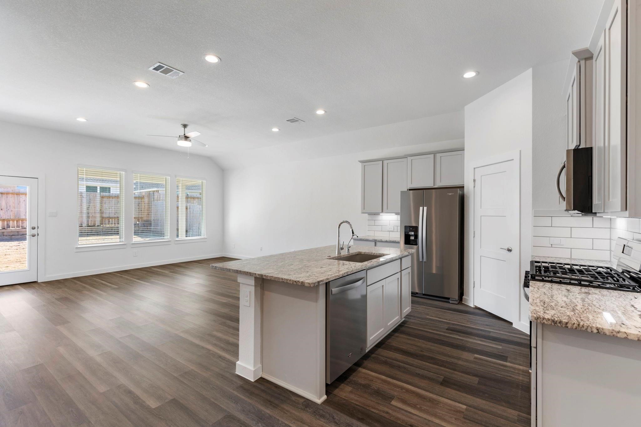 1644 Little Rabbit Court Montgomery, TX 77316 - Photo 15 of 27 a kitchen with stainless steel appliances granite countertop a sink stove and refrigerator