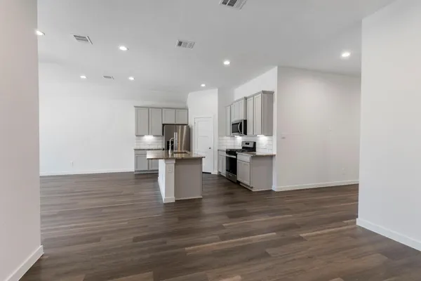 a kitchen with stainless steel appliances kitchen island wooden cabinets and granite counter tops
