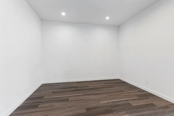 a view of room with wooden floor and fan