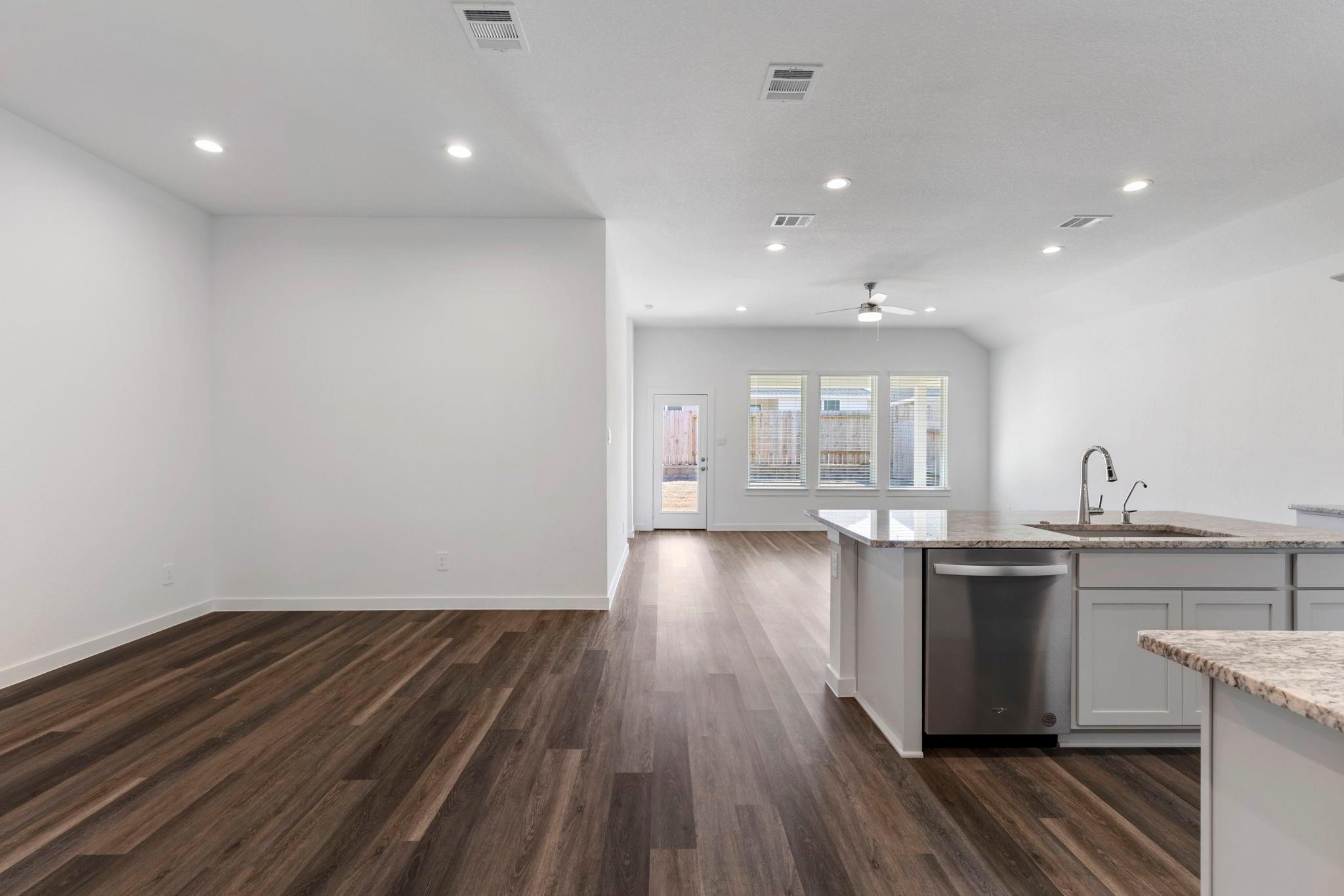 1644 Little Rabbit Court Montgomery, TX 77316 - Photo 18 of 27 a kitchen with kitchen island wooden floors and stainless steel appliances