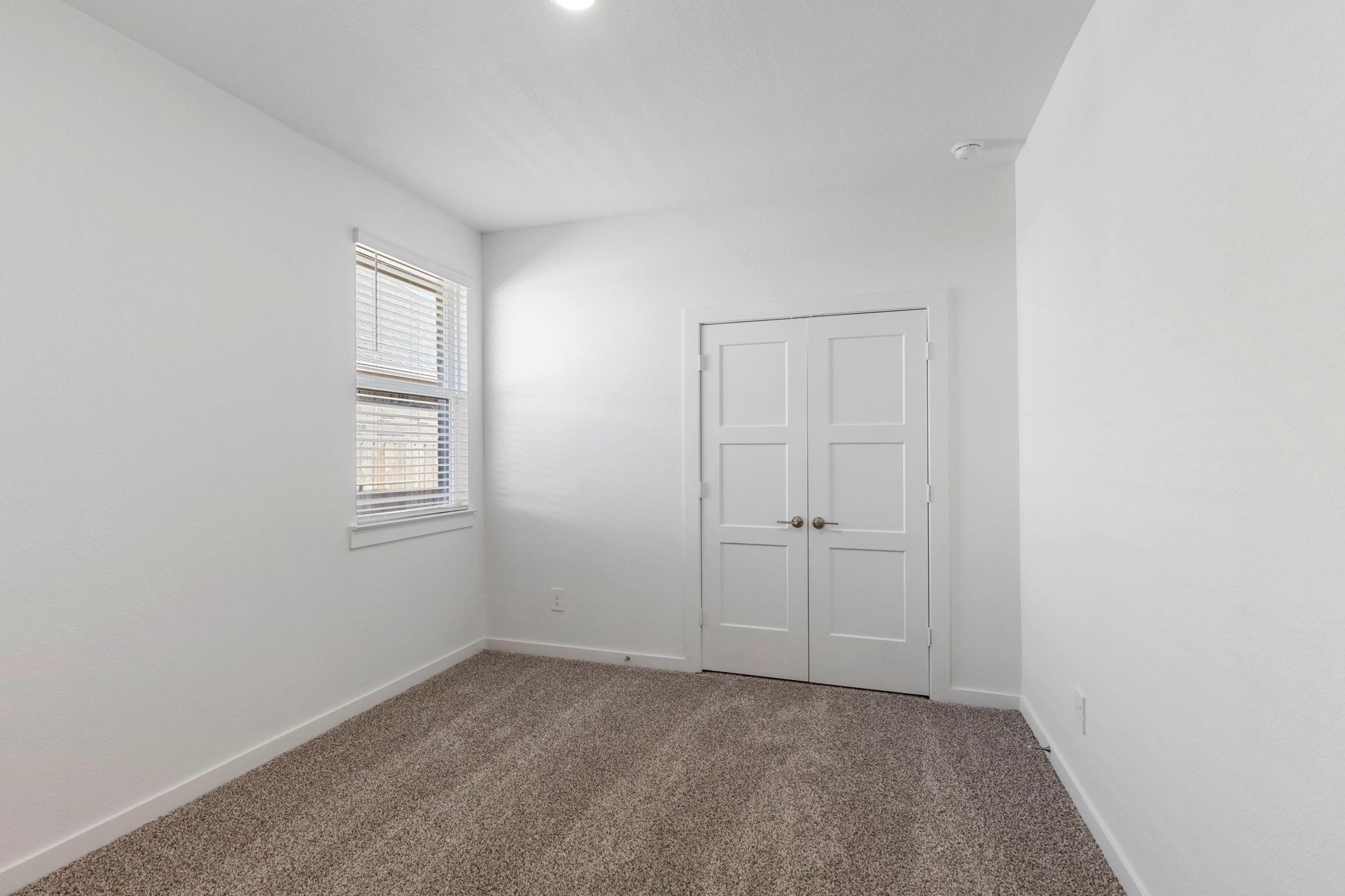 1644 Little Rabbit Court Montgomery, TX 77316 - Photo 21 of 27 a view of an empty room with closet and a window