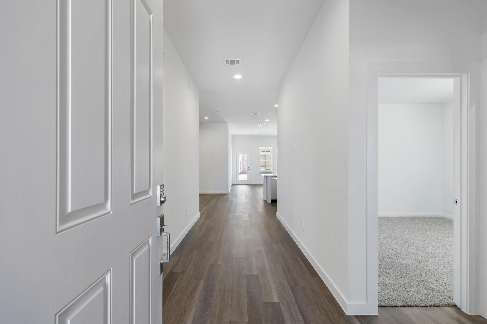1644 Little Rabbit Court Montgomery, TX 77316 - Photo 26 of 27 a view of a hallway with wooden floor and staircase