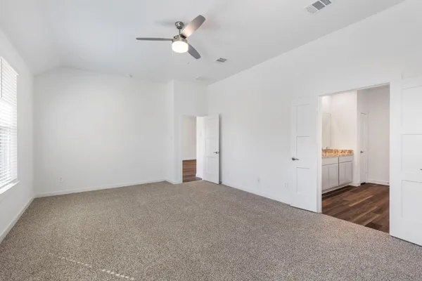 a view of a big room with closet and windows