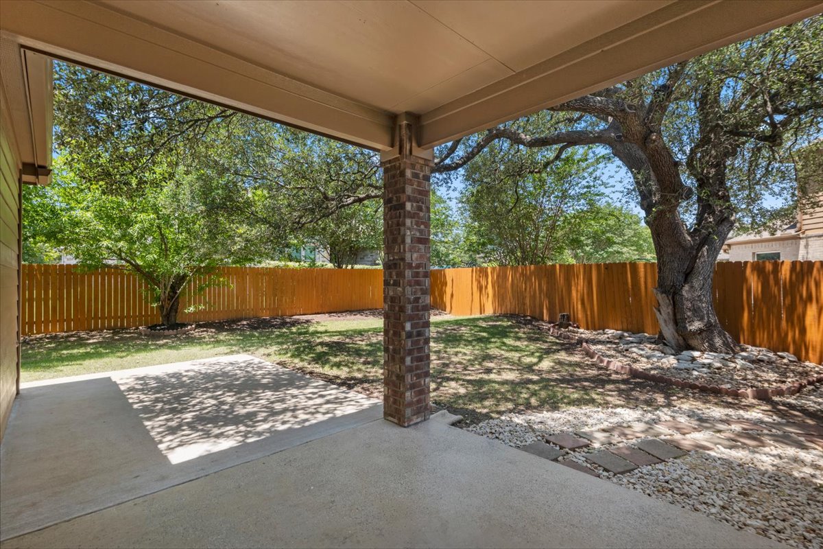 3451 Mayfield Ranch Boulevard, Unit 311 Round Rock, TX 78681 - Photo 39 of 40 Covered patio with a concrete surface, a brick column, and a gravel accent area with stepping stones