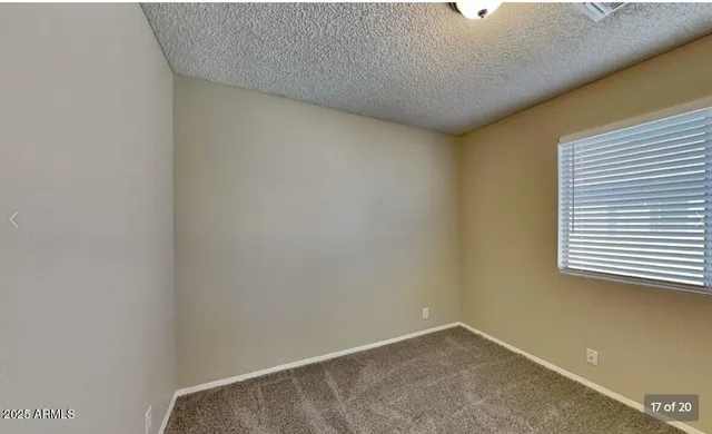 a view of an empty room and a window