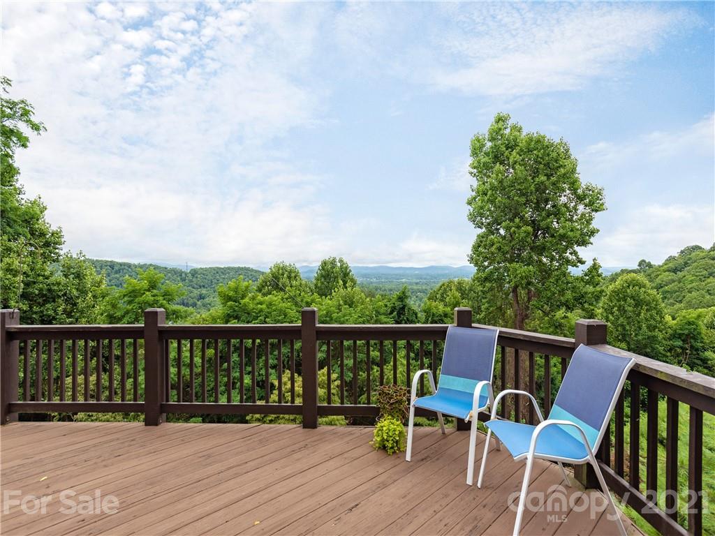 143 Country Ridge Road Hendersonville, NC 28739 - Photo 11 of 29 a view of a chair and table on the wooden floor