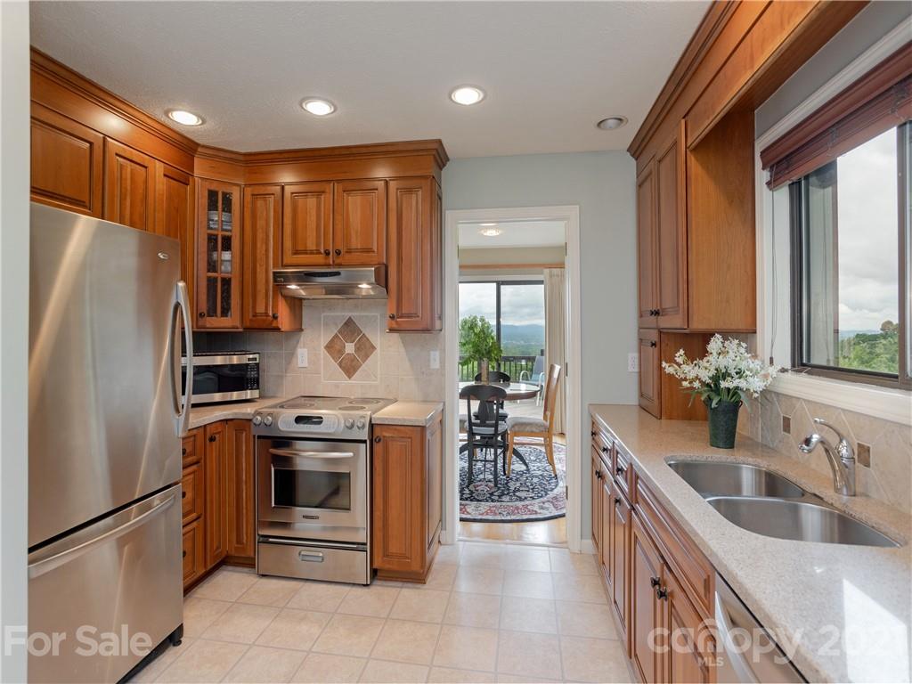 143 Country Ridge Road Hendersonville, NC 28739 - Photo 16 of 29 a kitchen with stainless steel appliances granite countertop a refrigerator a sink a stove and a refrigerator