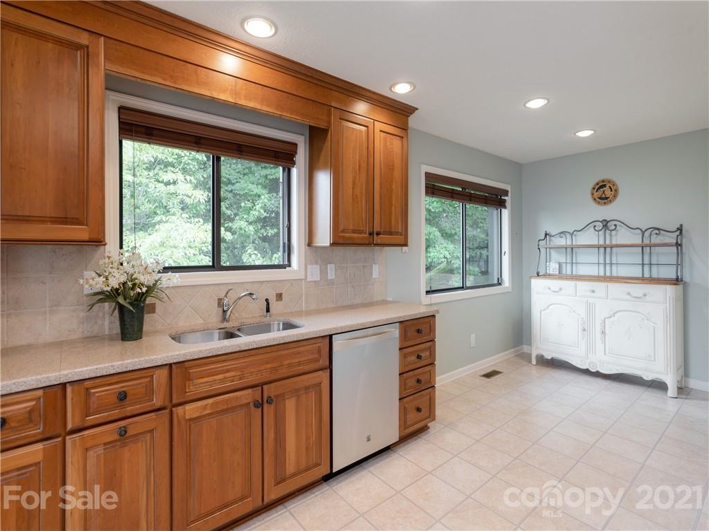 143 Country Ridge Road Hendersonville, NC 28739 - Photo 18 of 29 a kitchen with a sink window and cabinets