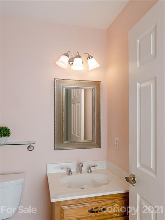 143 Country Ridge Road Hendersonville, NC 28739 - Photo 20 of 29 a bathroom with a sink and a mirror with toilet