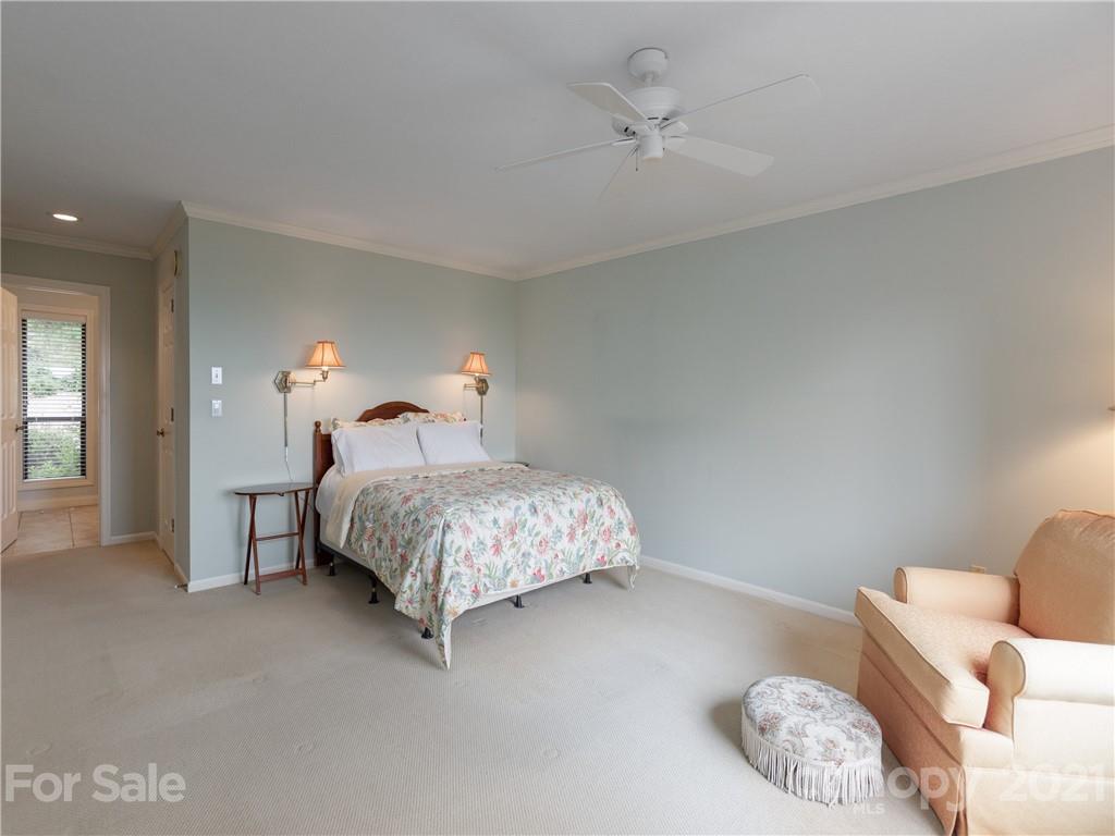 143 Country Ridge Road Hendersonville, NC 28739 - Photo 21 of 29 a bedroom with a bed flowerpot and window