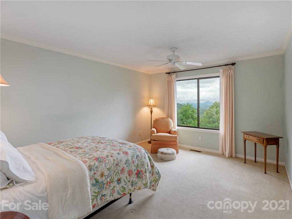 143 Country Ridge Road Hendersonville, NC 28739 - Photo 22 of 29 a bedroom with a bed and a couch with outer view