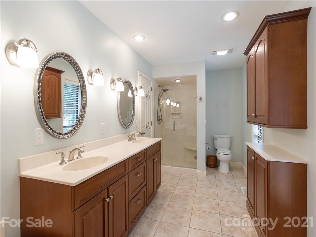 143 Country Ridge Road Hendersonville, NC 28739 - Photo 23 of 29 a spacious bathroom with a double vanity sink mirror and bathtub