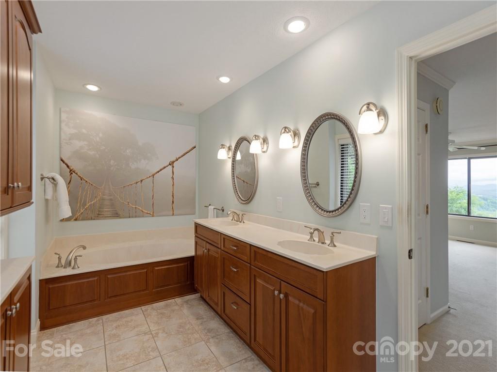 143 Country Ridge Road Hendersonville, NC 28739 - Photo 24 of 29 a bathroom with a double vanity sink mirror and bathtub