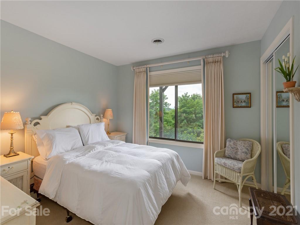 143 Country Ridge Road Hendersonville, NC 28739 - Photo 27 of 29 a bedroom with a bed and a large window